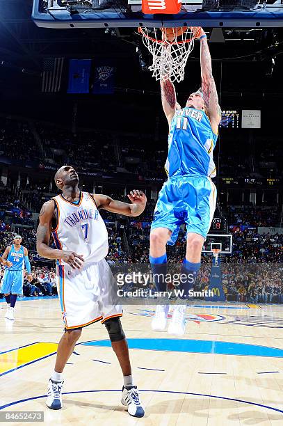 Chris Andersen of the Denver Nuggets completes a dunk against Joe Smith of the Oklahoma City Thunder at the Ford Center on February 4, 2009 in...