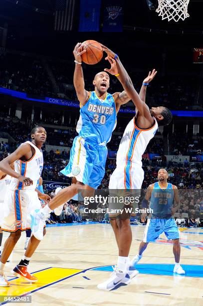 Dahntay Jones of the Denver Nuggets goes to the basket against Kyle Weaver of the Oklahoma City Thunder at the Ford Center on February 4, 2009 in...