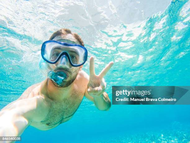 young man diving - snorkel beach stock-fotos und bilder