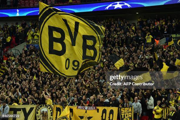 Dortmund supporters cheer on their team ahead of the UEFA Champions League Group H football match between Tottenham Hotspur and Borussia Dortmund at...