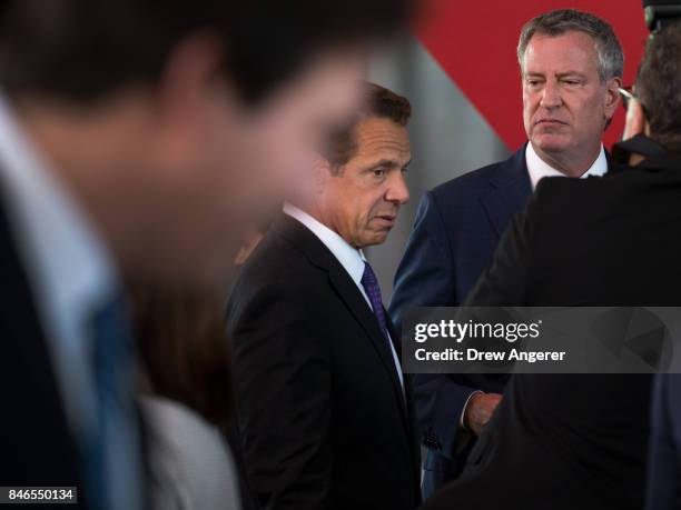 New York Governor Andrew Cuomo and New York City Mayor Bill de Blasio speak to each other briefly as they arrive for the dedication ceremony to mark...