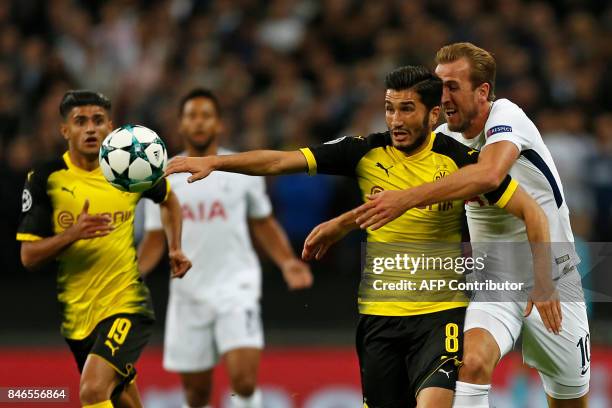 Tottenham Hotspur's English striker Harry Kane and Borussia Dortmund's Turkish midfielder Nuri Sahin tussle in the build up to the second Tottenham...