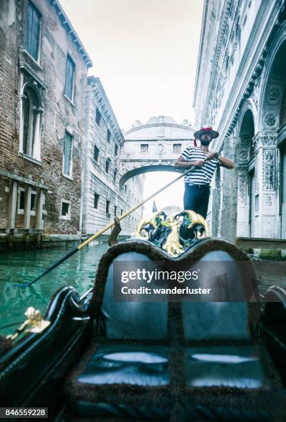 gondolier paddles past bridge of sighs - gondolier stock pictures, royalty-free photos & images