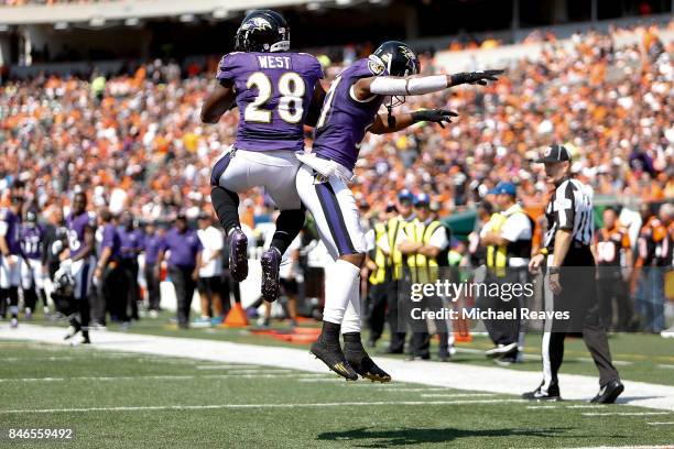 Terrance West of the Baltimore Ravens is congratulated by Javorius Allen of the Baltimore Ravens after scoring a touchdown during the second quarter...