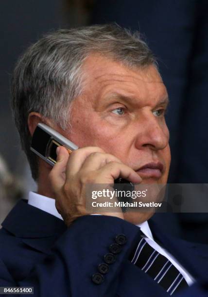 Russian businessman, Rosneft's President Igor Sechin speaks by a mobile phone while visiting a children's ice hockey match at the Shayba Arena on...