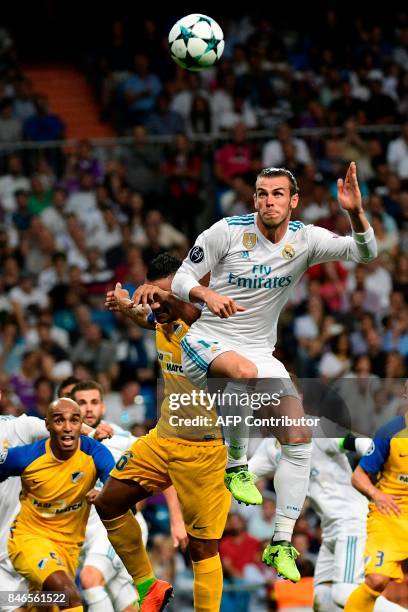 Real Madrid's forward from Wales Gareth Bale heads the ball during the UEFA Champions League football match Real Madrid CF vs APOEL FC at the...