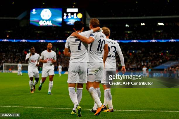 Tottenham Hotspur's English striker Harry Kane celebrates with teammates after scoring their second goal during the UEFA Champions League Group H...