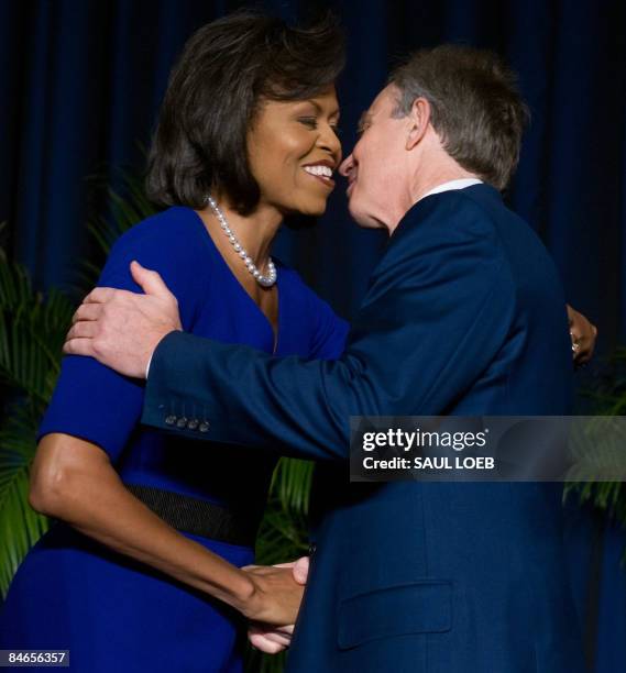 Former British Prime Minister Tony Blair embraces US First Lady Michelle Obama during the National Prayer Breakfast at the Washington Hilton in...