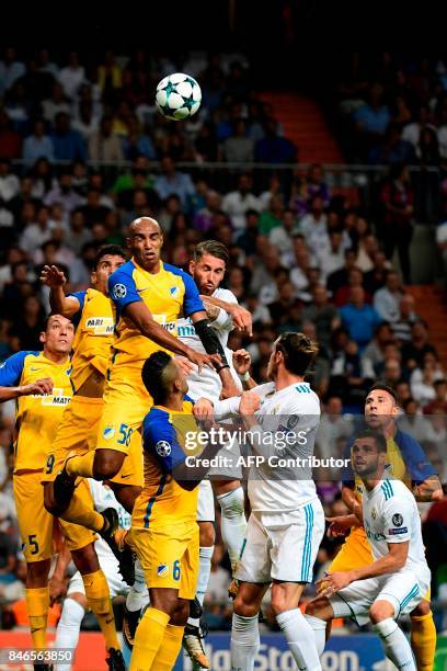 Real Madrid's defender from Spain Sergio Ramos heads the ball with APOEL's defender from Brazil Carlao during the UEFA Champions League football...