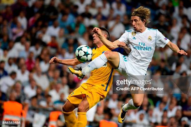 Nicosia's defender from Spain Roberto Lago vies with Real Madrid's midfielder from Croatia Luka Modric during the UEFA Champions League football...
