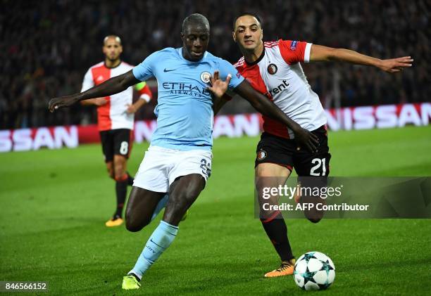 Manchester City's French defender Benjamin Mendy vies for the ball with Feyenoord's Moroccan midfielder Sofyan Amrabat during the UEFA Champions...