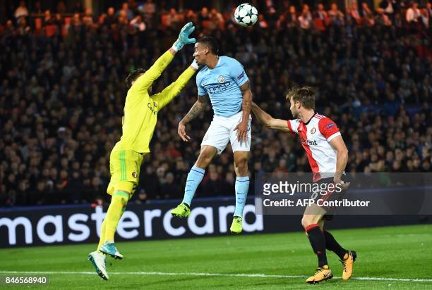 Manchester City's Brazilian striker Gabriel Jesus jumps for the ball with with Feyenoord's Australian goalkeeper Brad Jones during the UEFA Champions...