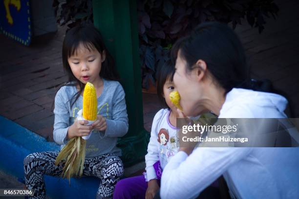 santa fe, nm, usa: eating sweet corn during fiesta celebrations - southwest food stock pictures, royalty-free photos & images