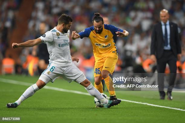 Real Madrid's defender from Spain Nacho Fernandez vies with APOEL Nicosia's midfielder from Cyprus Stathis Aloneftis during the UEFA Champions League...