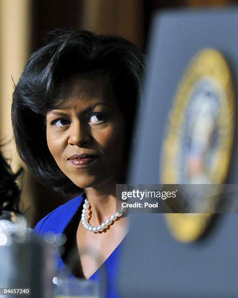 First lady Michelle Obama listens to U.S. President Barack Obama speak during the National Prayer Breakfast February 5, 2009 in Washington, DC....