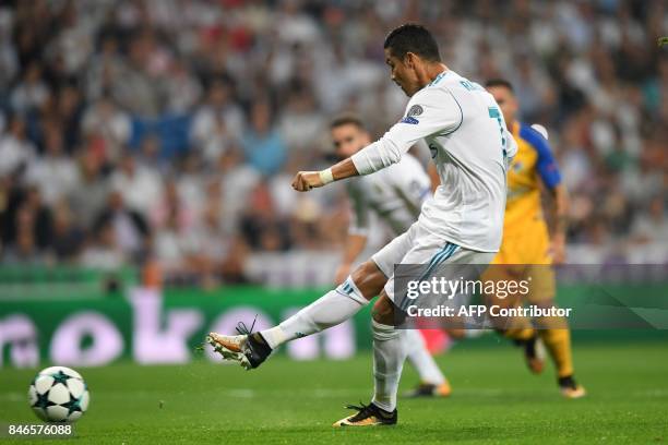 Real Madrid's forward from Portugal Cristiano Ronaldo scores on a penalty kick during the UEFA Champions League football match Real Madrid CF vs...