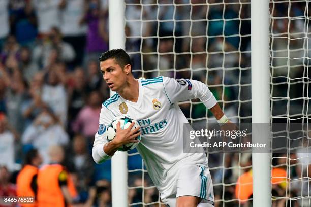 Real Madrid's forward from Portugal Cristiano Ronaldo celebrates after scoring on a penalty kick during the UEFA Champions League football match Real...