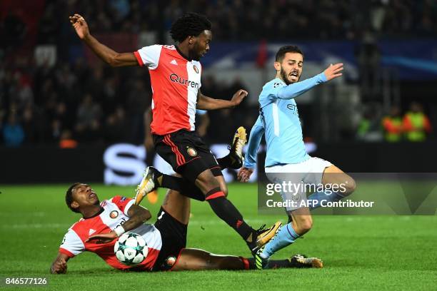 Manchester City's Portuguese midfielder Bernardo Silva vies for the ball with Feyenoord's Dutch defender Miquel Nelom and Feyenoord's Dutch striker...