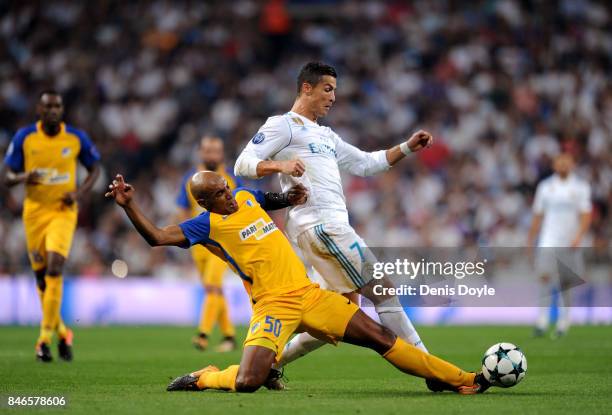 Carlao of Apoel FC tackles Cristiano Ronaldo of Real Madrid during the UEFA Champions League group H match between Real Madrid and APOEL Nikosia at...