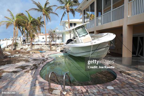 Boat is seen next to a home after Hurricane Irma passed through the area on September 13, 2017 in Duck Key, Florida. The Florida Key's took the brunt...