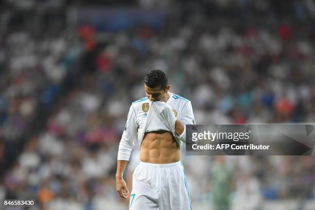 Real Madrid's forward from Portugal Cristiano Ronaldo wipes his face during the UEFA Champions League football match Real Madrid CF vs APOEL FC at...