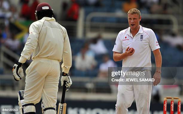 England's cricketer Andrew Flintoff grimaces after bowling as West Indies captain Chris Gayle looks on during the second day of the first Test match...