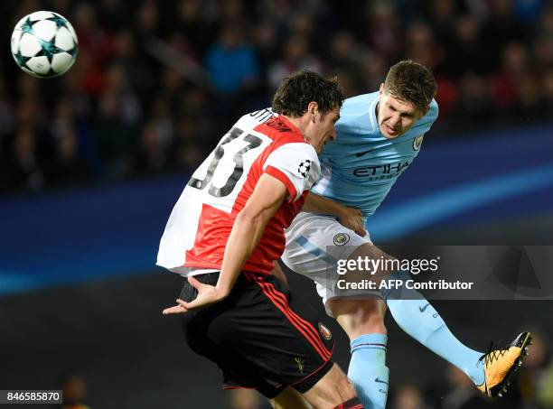 Manchester City's English defender John Stones heads the ball and scores a goal during the UEFA Champions League Group F football match between...