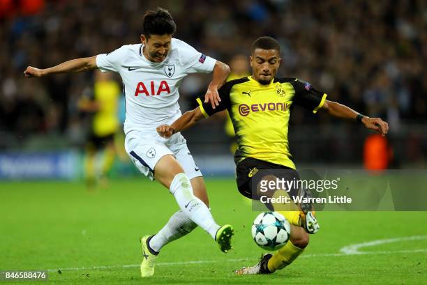 Heung-Min Son of Tottenham Hotspur shoots as Jeremy Toljan of Borussia Dortmund challenges during the UEFA Champions League group H match between...