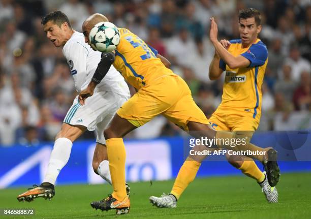 Real Madrid's forward from Portugal Cristiano Ronaldo vies with APOEL's defender from Brazil Carlao during the UEFA Champions League football match...
