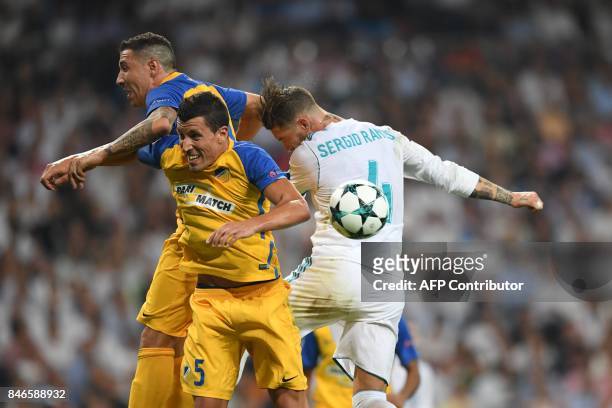 Nicosia's midfielder from Spain Jesus Rueda vies with Real Madrid's defender from Spain Sergio Ramos during the UEFA Champions League football match...