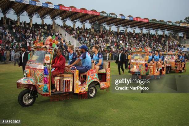 World-XI cricket team players waving the spectators while enjoying a ride on traditional tri-cycle rickshaw at Gaddafi Cricket Stadium in Lahore on...