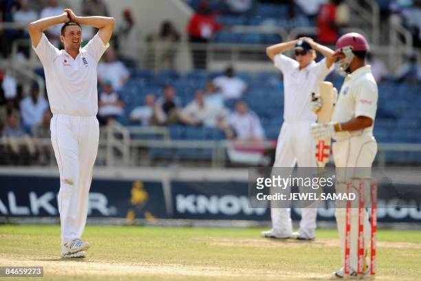 England's cricketer Steve Harmison reacts after missing a chance to dismiss West Indies batsman Ramnaresh Sarwan during the second day of the first...