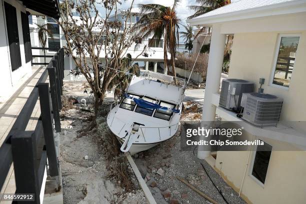 Fishing boat came to rest in between houses after being deposited there by Hurricane Irma's storm surge September 13, 2017 on Marathon, Florida. Many...