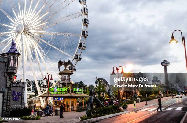 niagara falls skywheel and other attractions during summer twilight - niagara falls stock pictures, royalty-free photos & images