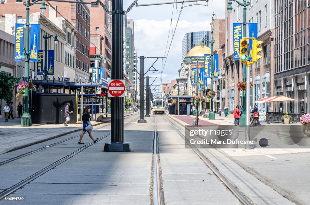 Main street of downtown Buffalo with cable car bus coming during summer day