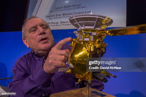 Team Lead for Cassini Ion and Neutral Mass Spectrometer, Southwest Research institute, Hunter Waite, points to a model of of NASA's Cassini...