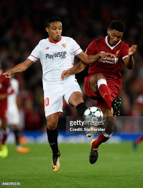 Luis Muriel of Sevilla and Joe Gomez of Liverpool battle for possession during the UEFA Champions League group E match between Liverpool FC and...