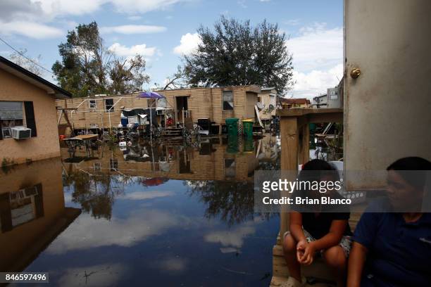 With their homes surrounded by water that they fear may be contaminated by waste water, residents deal with the aftermath of Hurricane Irma on...