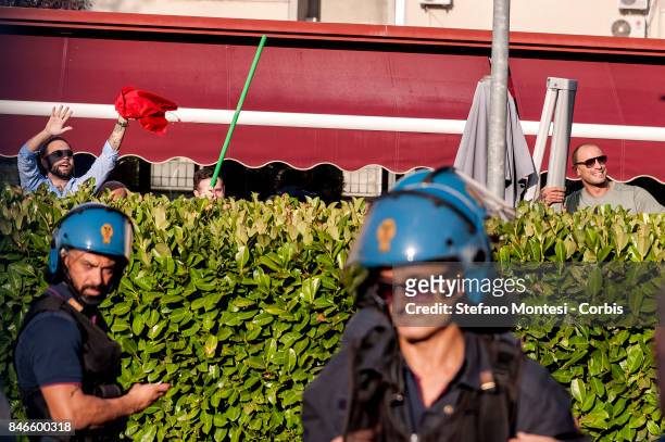 Some of Casapound's extreme right-wing wave a flag stolen from anti-fascists, after clashing with the group in front of the Fourth Town Hall, where...