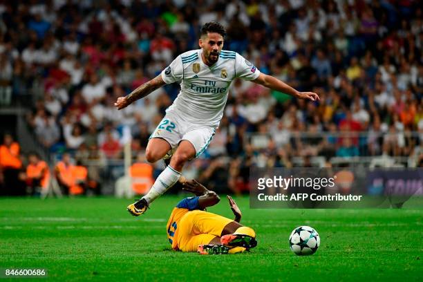 Real Madrid's midfielder from Spain Isco jumps to avoid an APOEL's player during the UEFA Champions League football match Real Madrid CF vs APOEL FC...