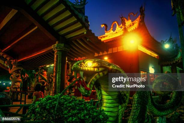 The lighting decoration of altar at night is the entertainment for ghosts is seen inside the Snake temple during Hungry ghost festivals in Teluk...