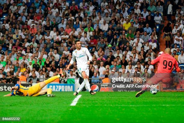 Real Madrid's forward from Portugal Cristiano Ronaldo kicks the ball past APOEL Nicosia's goalkeeper from the Netherlands Boy Waterman during the...