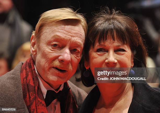 German actor Otto Sander and his wife Monika Hansen pose on the red carpet ahead of the premiere of the film "The International" by German director...