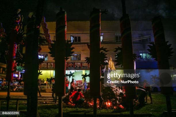 Members of ethnic Chinese make a last preparation in front of gods of ghost before being set on fire near the chinese temple during the Hungry Ghost...