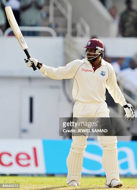 West Indies cricket team captain Chris Gayle acknowledges the crowd after scoring his half century during the second day of the first Test match...
