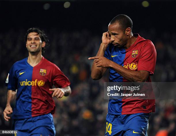 Thierry Henry of Barcelona celebrates scoring his sides opening goal flanked by his teammate Rafael Marquez during the Copa del Rey semi final first...