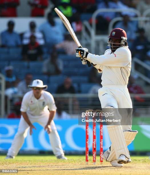 Chris Gayle of The West Indies hits out at a Steve Harmison delivery during day two of the 1st Test between The West Indies and England played at...