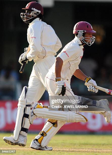 West Indies cricket team captain Chris Gayle and batsman Ramnaresh Sarwan take a run during the second day of the first Test match between England...