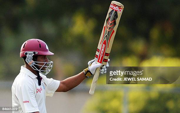 West Indies cricketer Ramnaresh Sarwan acknowledges the crowd after scoring his half century during the second day of the first Test match between...