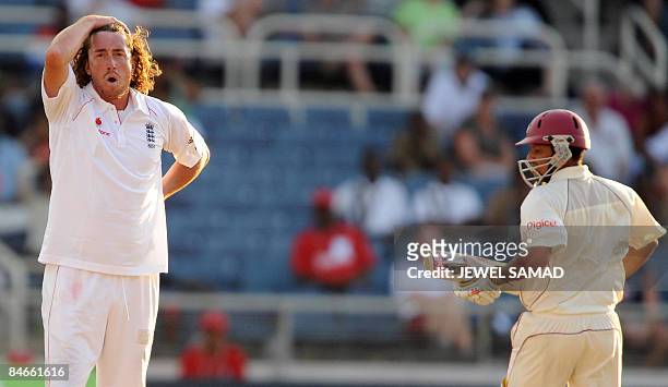 West Indies cricketer Ramnaresh Sarwan takes a run as England's bowler Ryan Sidebottom reacts during the second day of the first Test match between...